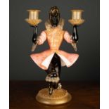 A Murano glass candelabrum formed as a kneeling Blackamore figure, a candle sconce in each hand,