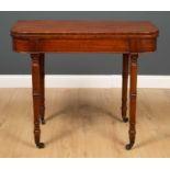 A 19th century mahogany card table, the fold out top with blue baize surface on four turned supports