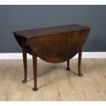 A George III mahogany drop leaf table with turned legs, 107cm wide x 37cm deep (flaps down) x 75cm