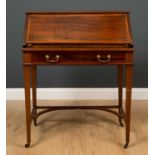 An Edwardian mahogany bureau, the drop front over green leather inset top and fitted interior,