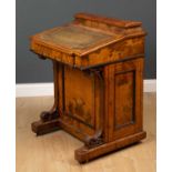 An early Victorian walnut davenport the correspondence compartment above a green leather inset
