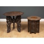 An Eastern carved hardwood octagonal table 63cm wide x 61cm high and a further Eastern folding table