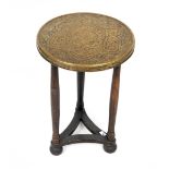 An early 20th century Oriental brass topped circular occasional table with turned supports and bun