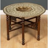 An early 20th century Eastern brass tray topped Benares table the tray 75cm diameter x overall