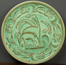 A Burleigh ware art deco style green pottery charger, decorated with deer within a foliate border,