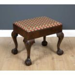 An Antique George III style walnut foot stool with an upholstered inset seat, cabriole legs and claw