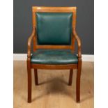A Brights of Nettlebed carved oak and green leather upholstered desk chair, with foliate