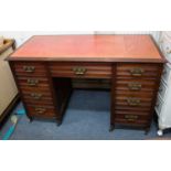 An Edwardian mahogany pedestal desk with a red leather inset top, nine drawers, 191cm wide x 55cm