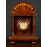 An antique burrwood clock case with turned pillar supports and bun feet, with inset clock with