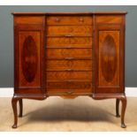 An early 20th century mahogany music or filing cabinet the top drawer opening, the side panel