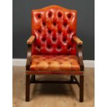 A red leather button upholstered open armchair with a studded edge and square legs, 65cm wide x 66cm