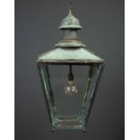 A large copper hall lantern with four sloped and tapering glass sides within copper frame, converted