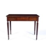 Mahogany side table Early 19th Century, with two fitted frieze drawers on fluted legs on castors,