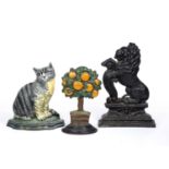 Three cast iron door stops one of a rampant lion, 38cm high, one of a seated cat with painted