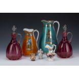 Pair of cranberry glass ewers 24cm high, two Staffordshire 'Josiah Wedgwood' jugs, 25cm and 19cm,
