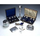 Group of silver pieces to include a cased set of six silver apostle top coffee spoons and tongs, a