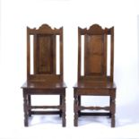 Pair of oak wainscot chairs 17th Century style with panelled back and carved top rails, 47cm wide