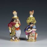 Two Sitzendorf porcelain scent bottles modelled as shepherd/tailor and his wife and a harvest scene,