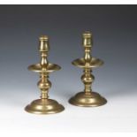 Pair of brass candlesticks with wide circular drip trays on knopped stems, terminating in socle