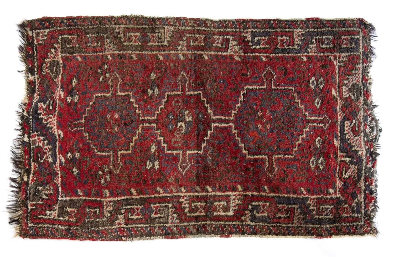 Red ground rug Afghanistan, with three central medallions, 121cm x 77cmCondition report: Worn with