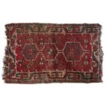 Red ground rug Afghanistan, with three central medallions, 121cm x 77cmCondition report: Worn with