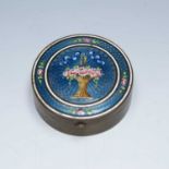 Blue enamel and brass pill box circa 1900, painted with a basket of roses, 6cm diameterCondition