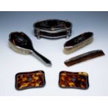 Collection of tortoiseshell items consisting of: a silver and piquet work dressing table box,