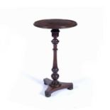 Oak circular topped tripod table 19th Century on turned tapering stem terminating in three bun feet,