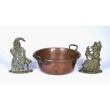 Large copper two handled pan 48.5cm across, and two brass door stops in the form of Punch and