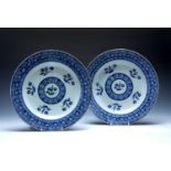 Pair of Delft blue and white chargers Dutch, 18th Century, each with a central circular bad and