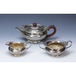 Three-piece Victorian silver tea set consisting of a squat teapot, twin handled sucrier and milk/