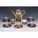 In the manner of Royal Crown Derby Imari patterned coffee service, each piece marked with a red