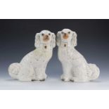 Pair of Staffordshire spaniels white with gold painted decoration, unmarked to the base, 32.5cm