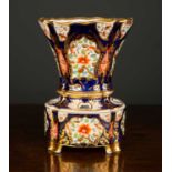 An early 19th Century Spode flower vase and stand, the blue and gilt background with floral