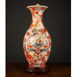 An 18th century Chinese baluster vase formed as a table lamp, the white ground decorated with floral