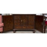 An 18th century Dutch mahogany and marquetry small side cupboard, inlaid with urns of flowers within