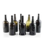 A group of eight sealed wine bottles, cylinders, each seal stamped A.S.C.R. (All Souls Common Room),