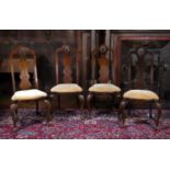 A set of four 18th century and later mahogany side chairs, the tall backs with scallop carved vase