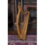 An Irish Arts & Crafts Celtic revival beechwood and elm harp, by James McFall, Belfast, having