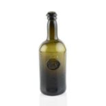 A sealed wine bottle, cylinder, seal stamped with a stag and foliage above the initial 'M' (