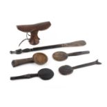 Three Lozi wooden cooking ladles; another similar; a Zimbabwe cooking utensil with bird finial;