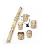 A group of five early 20th century Japanese ivory small noh masks, with carved and pierced features,