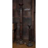 A 19th century mahogany torchere with turned and reeded column, foliate carved feet, 158cm high, the