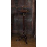 An early 19th century mahogany reading or candle stand, the galleried rectangular top with raised