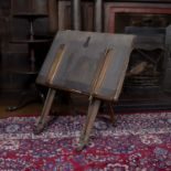 A late Victorian oak folio stand with easel type support and with Morocco leather covered fall, 82cm