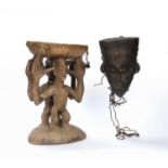 Carved tribal stool, with two figures decorated with beads holding up a seat, 41cm high, and an