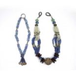 Two African Large blue and clear glass trade bead necklaces, with millefiori beads, wood and