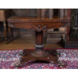 An early Victorian rosewood fold over top card table with foliate carved octagonal column, concave