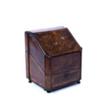 A 19th century Continental walnut and inlaid stationery box, the sloping hinged top inlaid with a