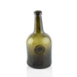 A sealed wine bottle, squat cylinder, seal stamped I.C. Esq, 23cm high